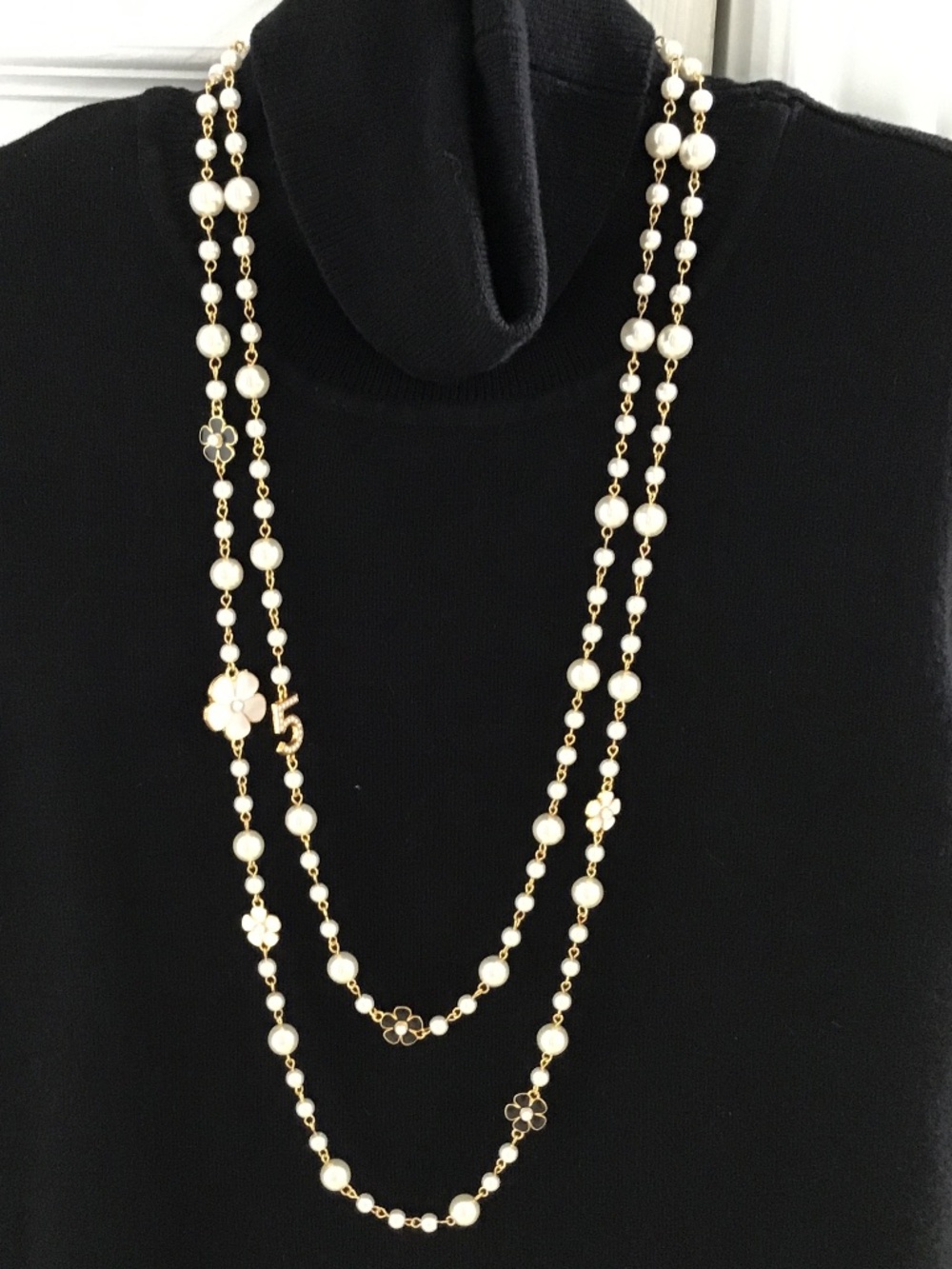 White and gold tone faux pearl double strand necklace with a hint of black